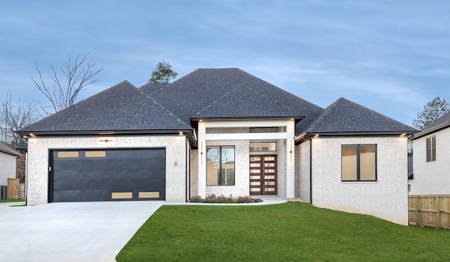 view of front of property with a garage and a front lawn