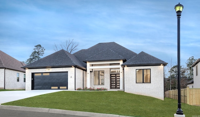 view of front facade with a garage and a front lawn