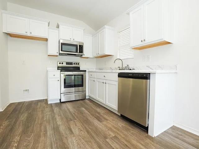 kitchen featuring white cabinetry, sink, dark hardwood / wood-style flooring, and stainless steel appliances