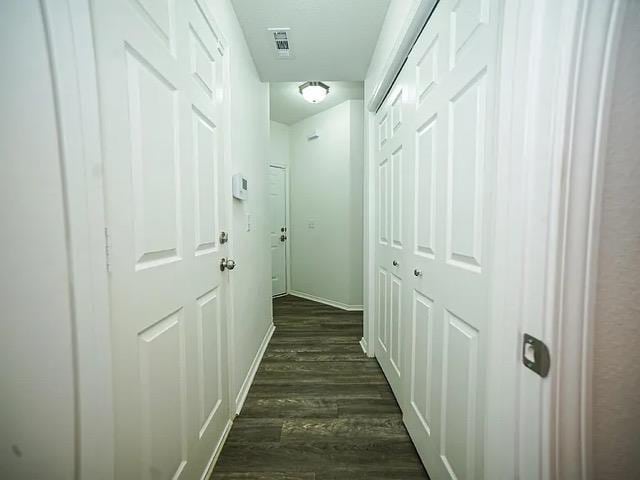 corridor featuring dark hardwood / wood-style flooring