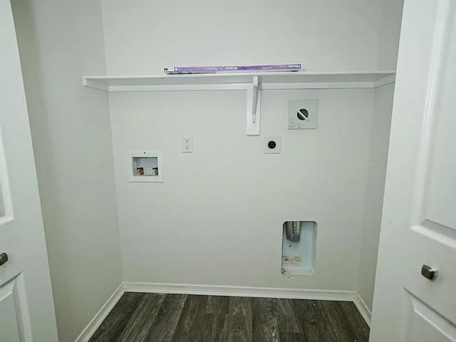 laundry room featuring electric dryer hookup, dark hardwood / wood-style floors, and washer hookup