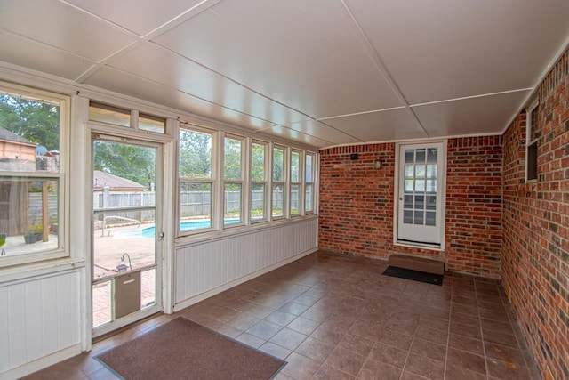 unfurnished sunroom featuring a healthy amount of sunlight