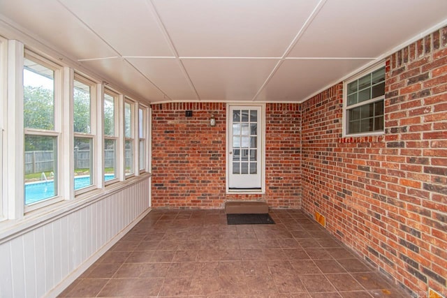 unfurnished sunroom featuring a wealth of natural light