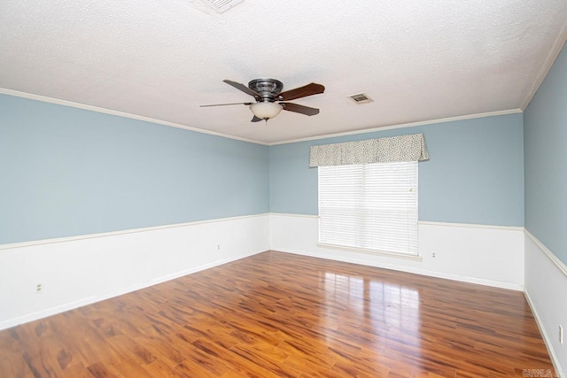 unfurnished room with crown molding, ceiling fan, hardwood / wood-style flooring, and a textured ceiling