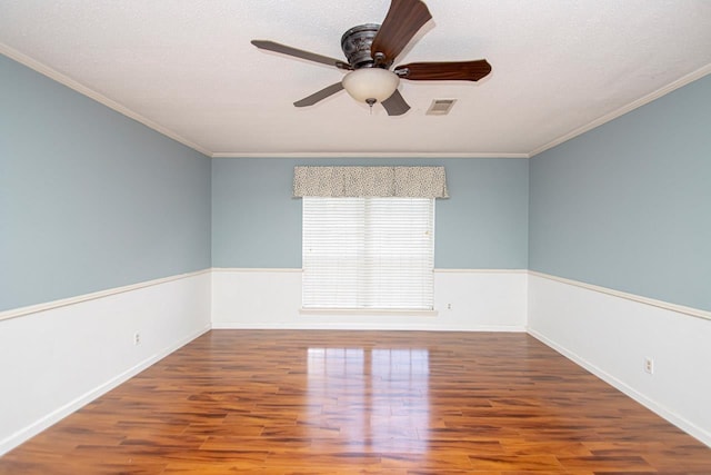 unfurnished room featuring wood-type flooring, ceiling fan, and crown molding