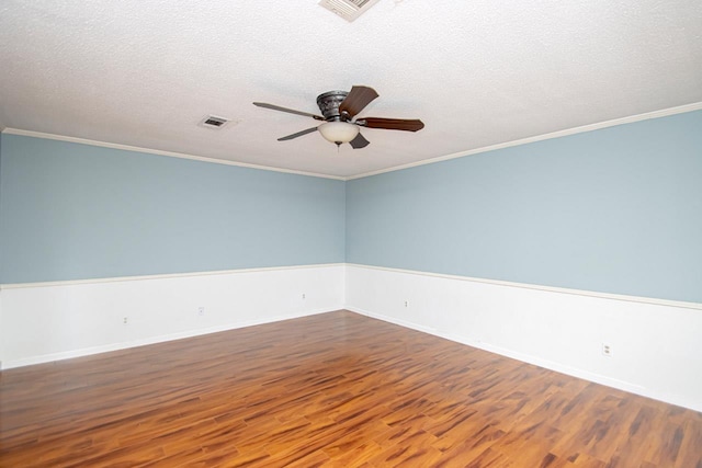 spare room with crown molding, ceiling fan, wood-type flooring, and a textured ceiling