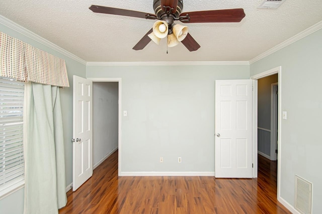 unfurnished bedroom featuring dark hardwood / wood-style flooring, crown molding, and a textured ceiling