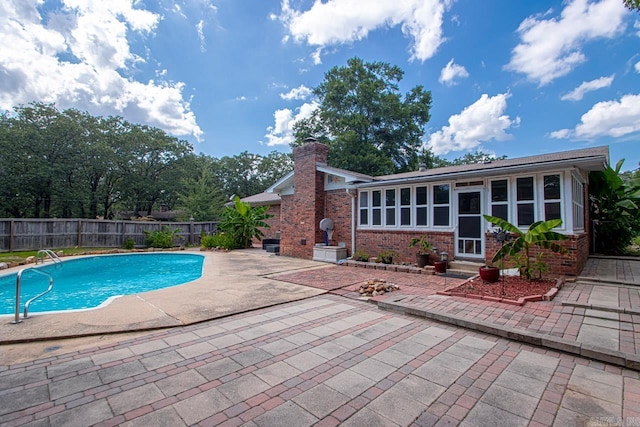 view of swimming pool with a patio