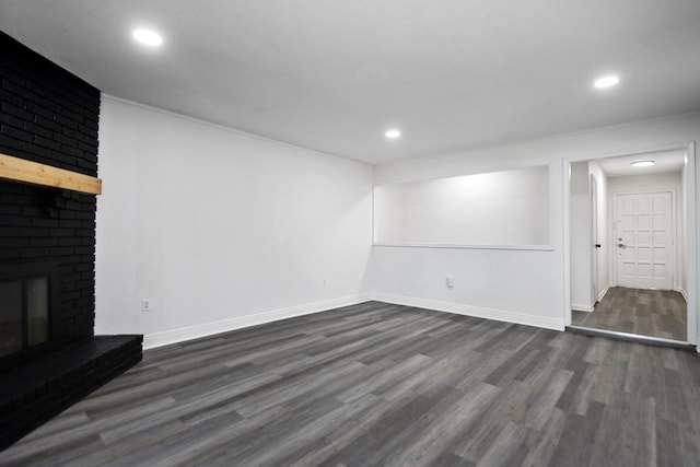 unfurnished living room featuring dark hardwood / wood-style flooring and a fireplace