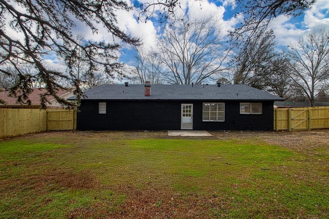 rear view of house with a lawn