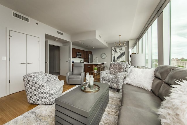 living room with sink and light hardwood / wood-style flooring