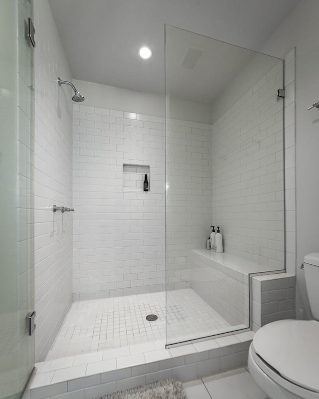 bathroom featuring toilet and an enclosed shower