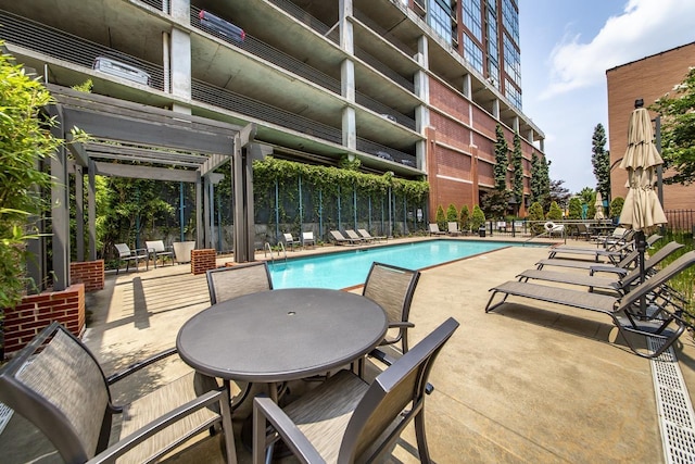 view of swimming pool with a patio and a pergola