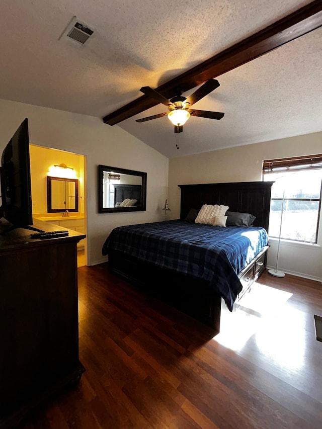 bedroom featuring lofted ceiling with beams, dark hardwood / wood-style floors, and a textured ceiling