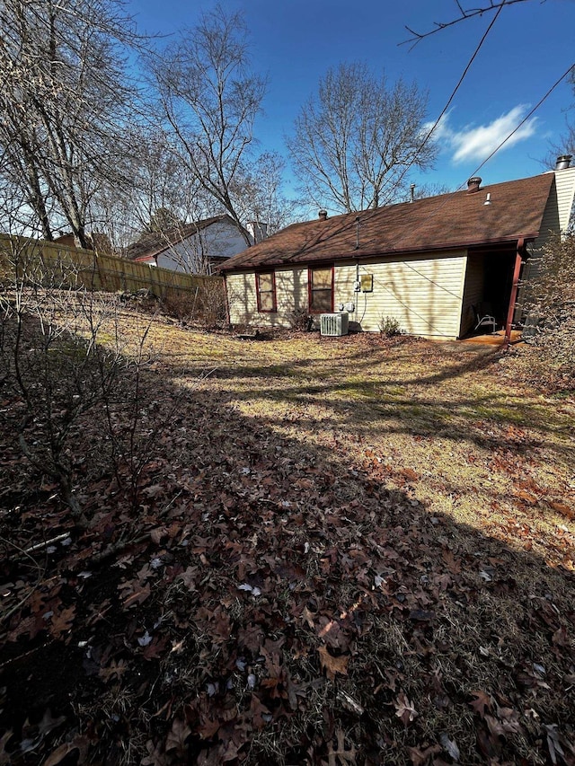 back of house with central air condition unit