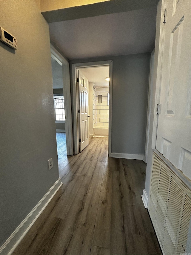 corridor featuring dark wood-type flooring