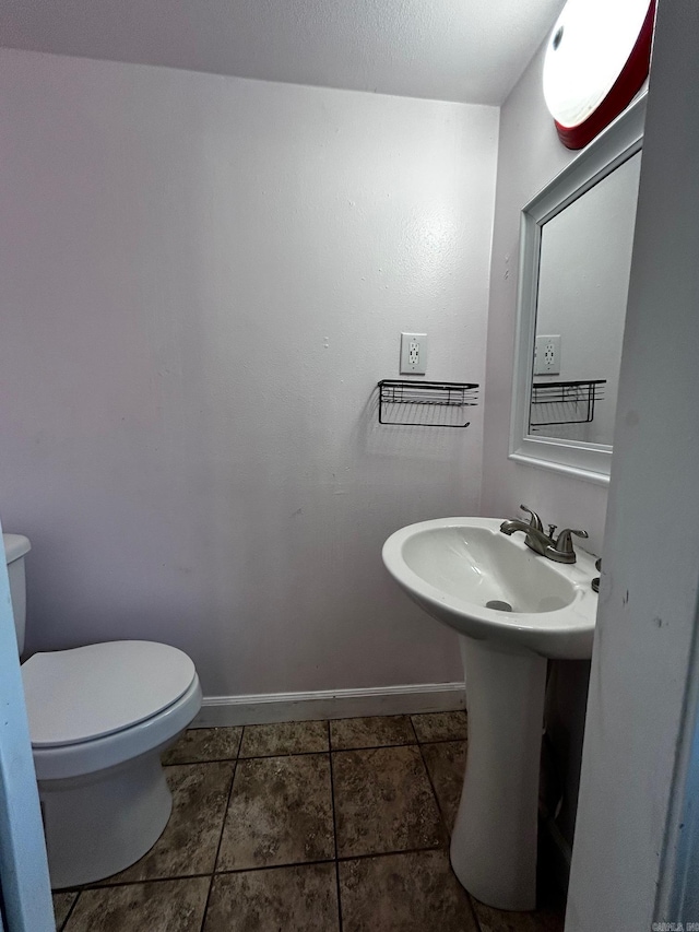 bathroom featuring sink, tile patterned floors, and toilet