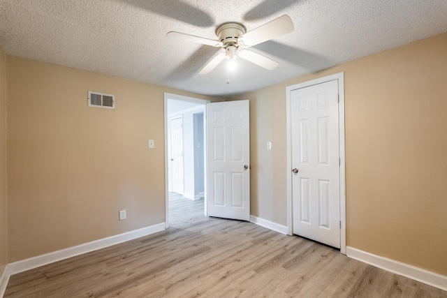 unfurnished bedroom with ceiling fan, a textured ceiling, and light hardwood / wood-style flooring