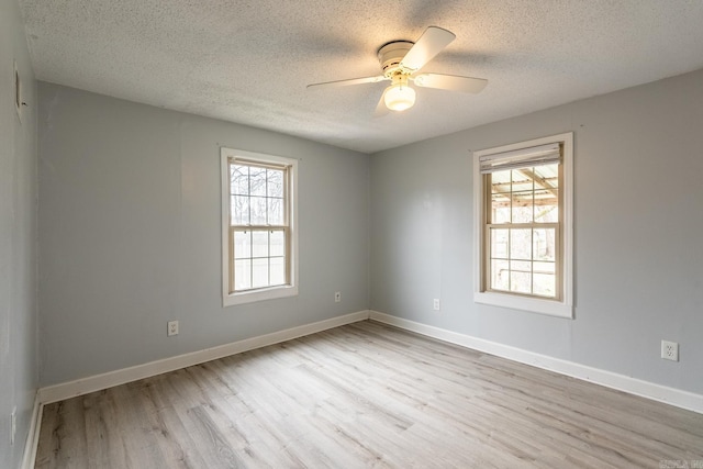 empty room featuring a textured ceiling, ceiling fan, and light hardwood / wood-style flooring