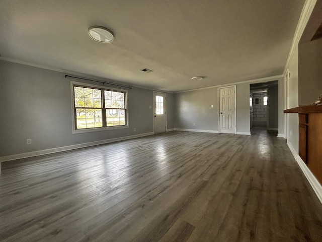 unfurnished living room with ornamental molding and dark wood-type flooring