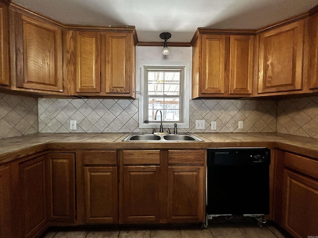 kitchen with tile countertops, dishwasher, sink, and decorative backsplash