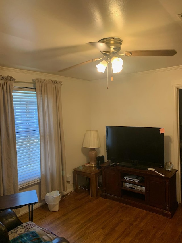 living room featuring crown molding, ceiling fan, and dark hardwood / wood-style flooring