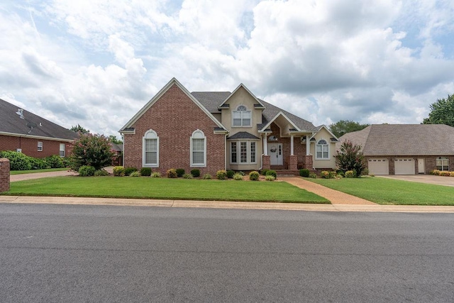 view of front of home with a garage and a front lawn