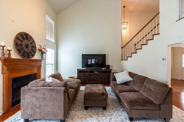 living room featuring high vaulted ceiling and hardwood / wood-style floors