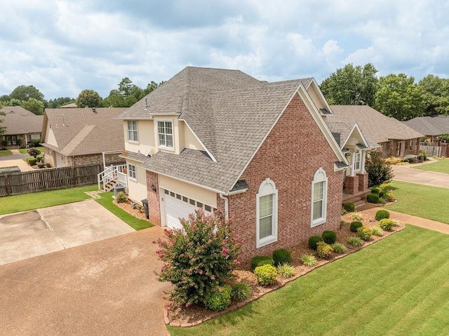 view of front of house featuring a garage and a front lawn