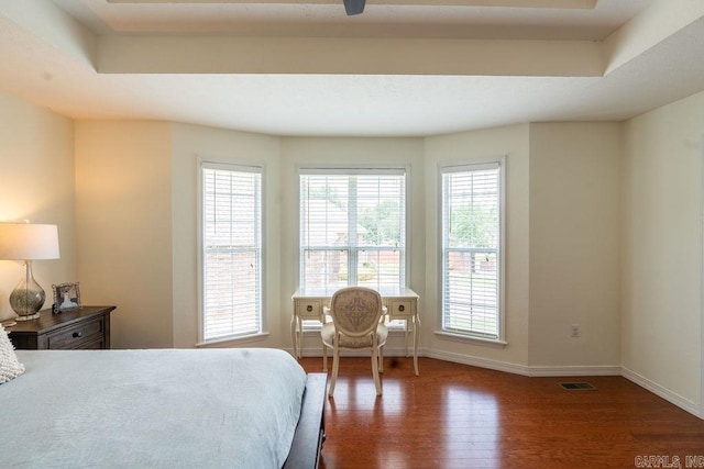 bedroom with dark hardwood / wood-style floors