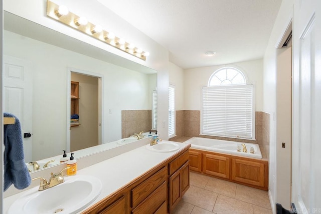 bathroom with a bathing tub, tile patterned floors, and vanity