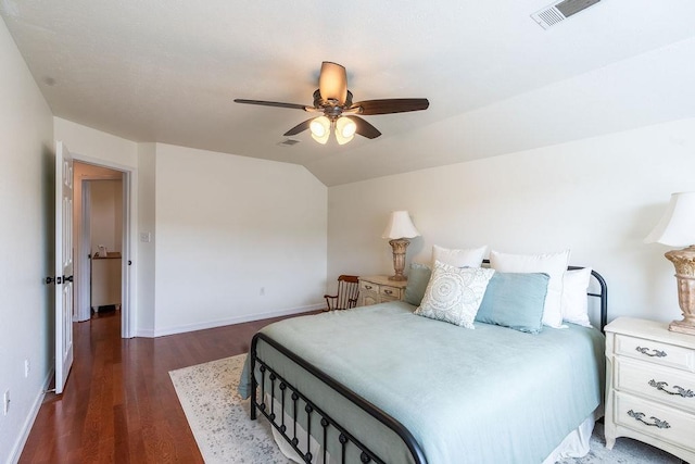 bedroom featuring dark wood-type flooring, vaulted ceiling, and ceiling fan