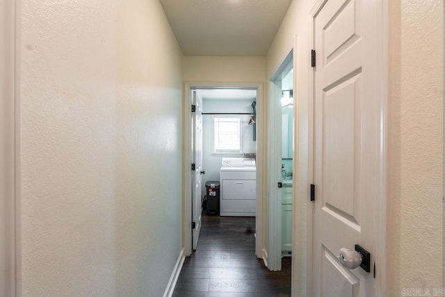 hall with washer / dryer and dark hardwood / wood-style floors