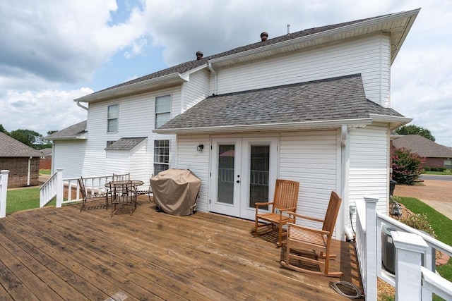 rear view of house featuring a wooden deck and french doors