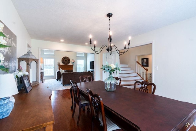 dining space featuring wood-type flooring and an inviting chandelier