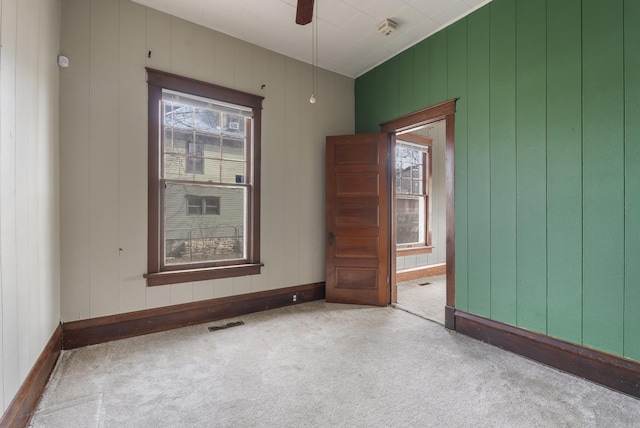 spare room with light colored carpet and ceiling fan