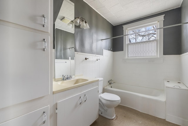 full bathroom featuring vanity, shower / bathing tub combination, tile walls, and toilet