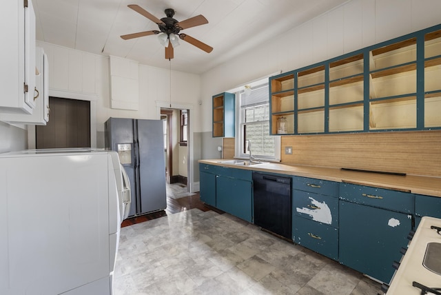 kitchen featuring refrigerator with ice dispenser, sink, black dishwasher, white cabinets, and washer / clothes dryer