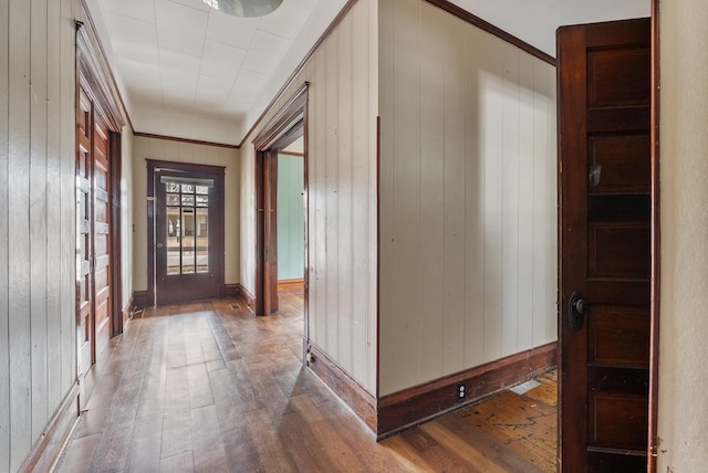 entryway featuring wood-type flooring and crown molding