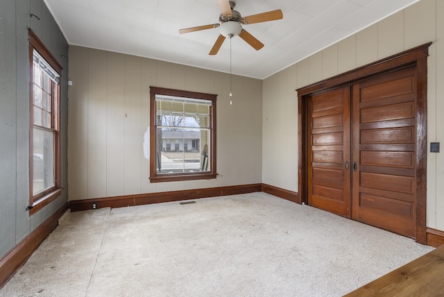 carpeted empty room with ceiling fan