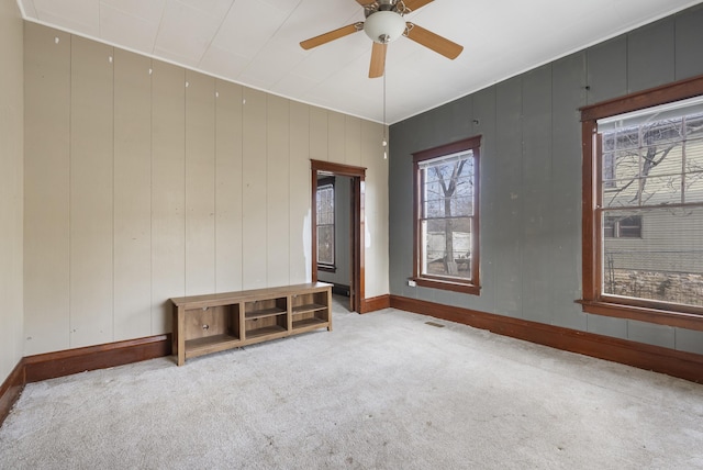 carpeted empty room featuring ceiling fan