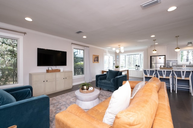 living room featuring hardwood / wood-style flooring and ornamental molding