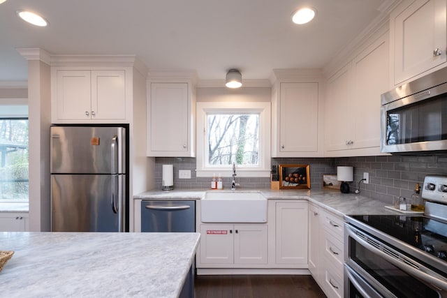 kitchen featuring white cabinetry, sink, crown molding, and appliances with stainless steel finishes