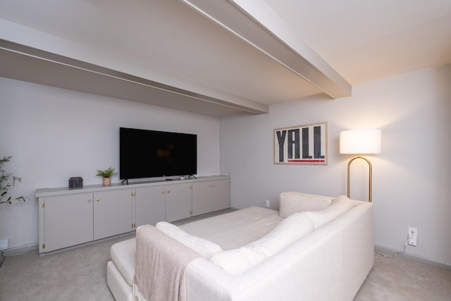 living room with beamed ceiling and light colored carpet