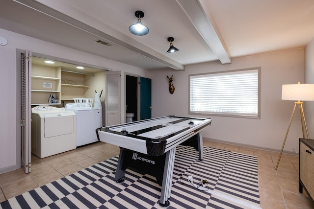 playroom featuring washer and clothes dryer, beamed ceiling, and light tile patterned flooring