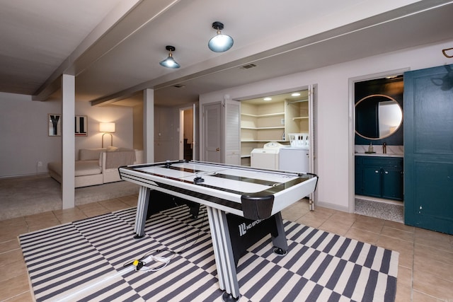 game room featuring beam ceiling, sink, washer and dryer, and light tile patterned floors