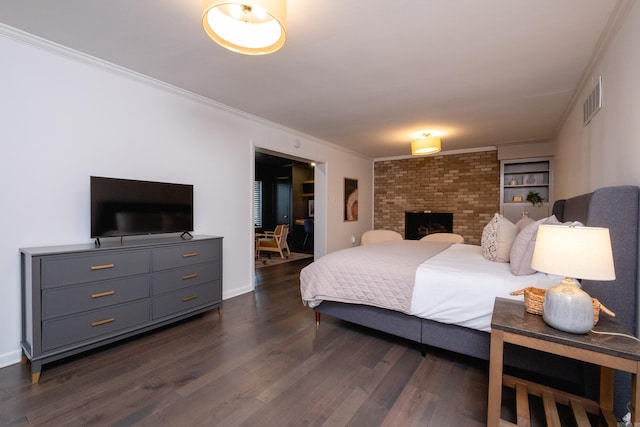 bedroom featuring ornamental molding and dark hardwood / wood-style flooring