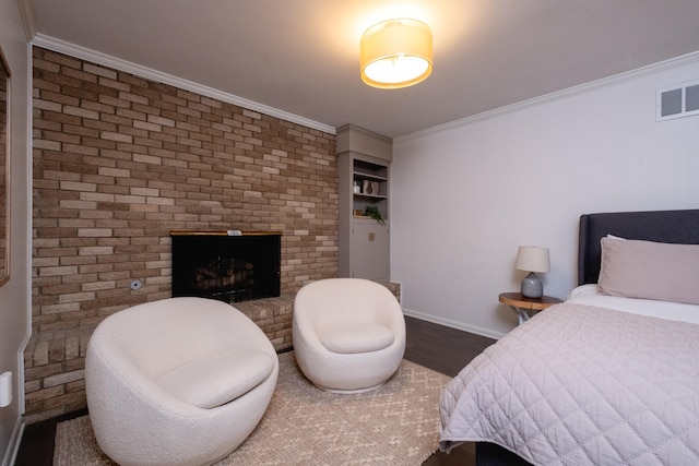 bedroom with ornamental molding, a brick fireplace, and dark wood-type flooring