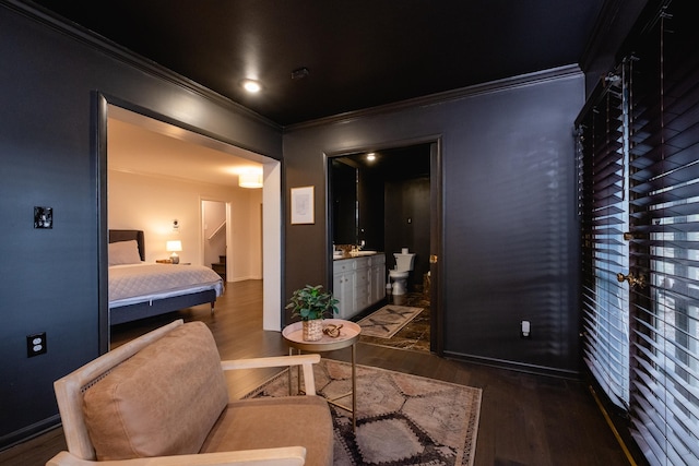 bedroom with ornamental molding, dark hardwood / wood-style floors, and ensuite bathroom