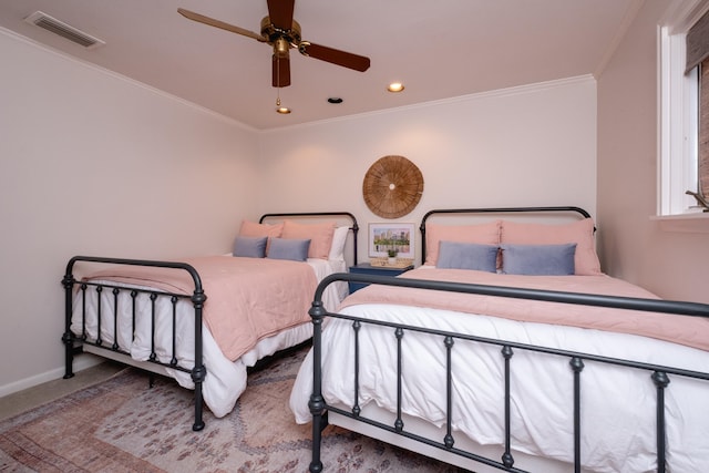 bedroom with ornamental molding, carpet, and ceiling fan